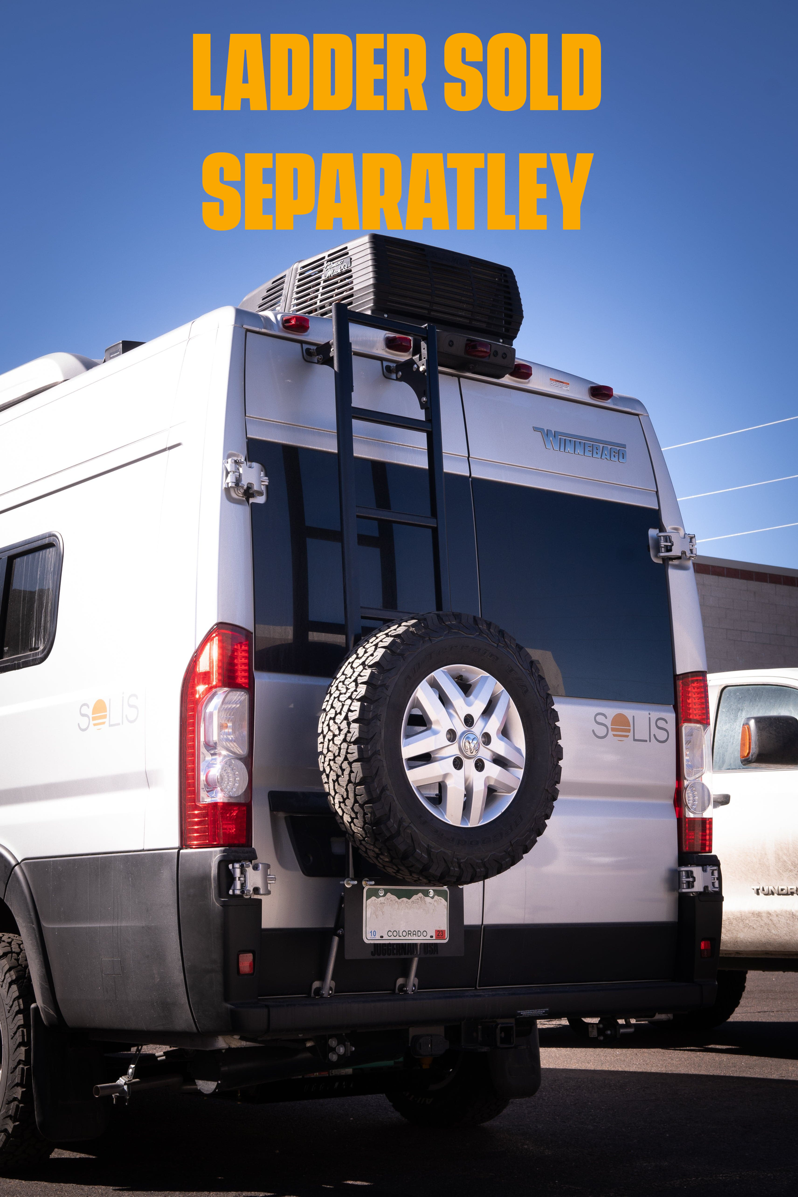 Juggernaut USA rear spare tire rack mounted to a Ram ProMaster rear door alongside a Prime Design ladder