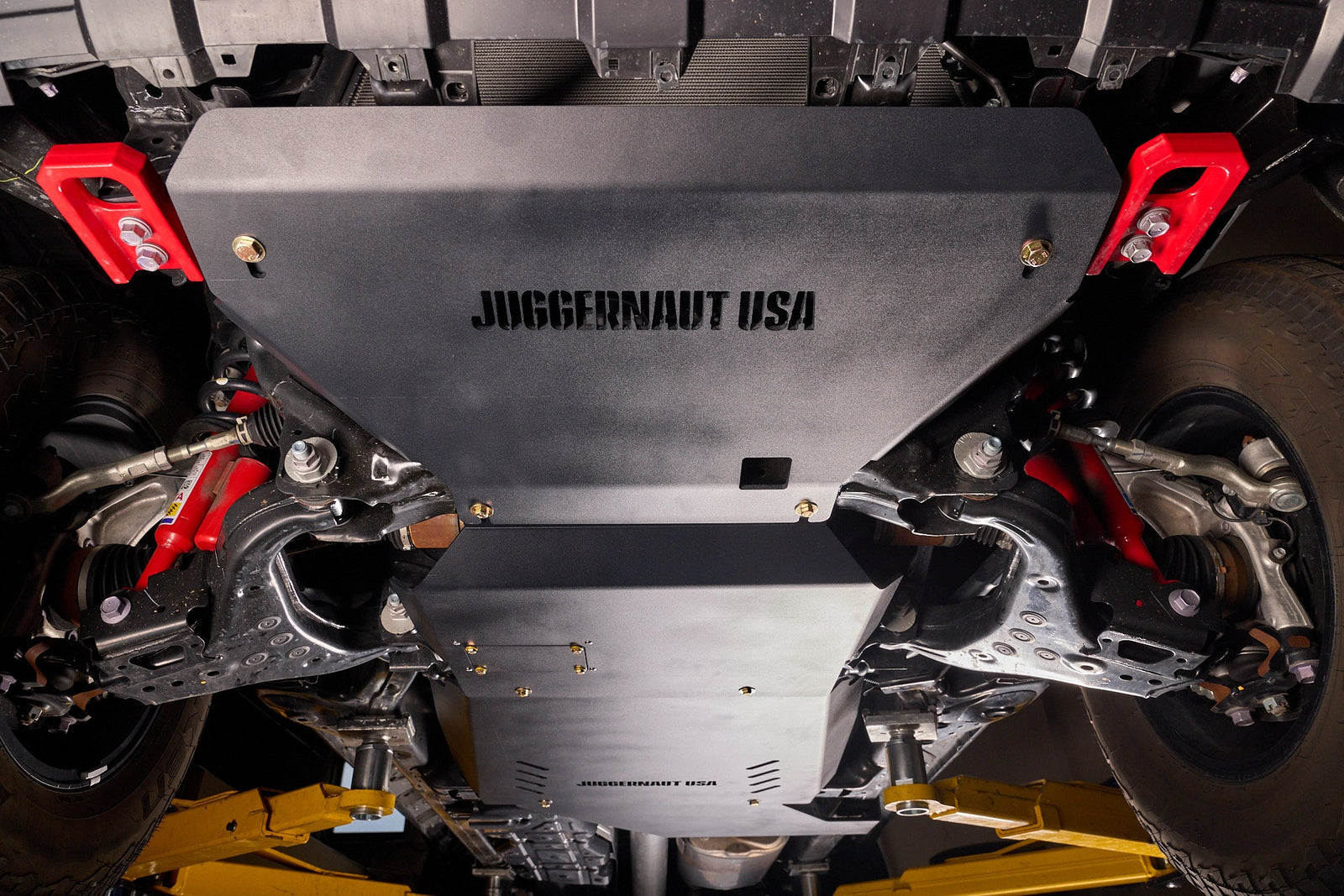 Aluminum skid plates covering the engine and transmission on a 4WD truck, viewed from below