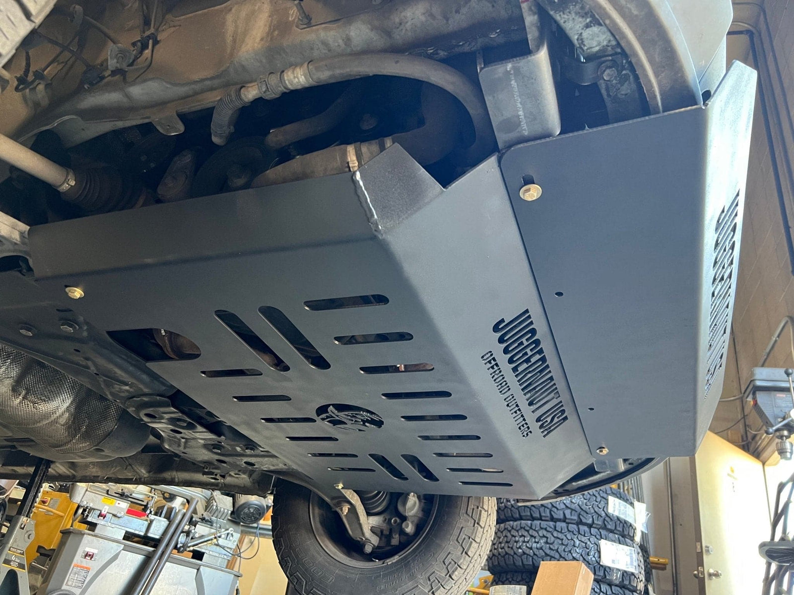 1/4 inch powder-coated aluminum skid plate covering a vehicle's catalytic converter