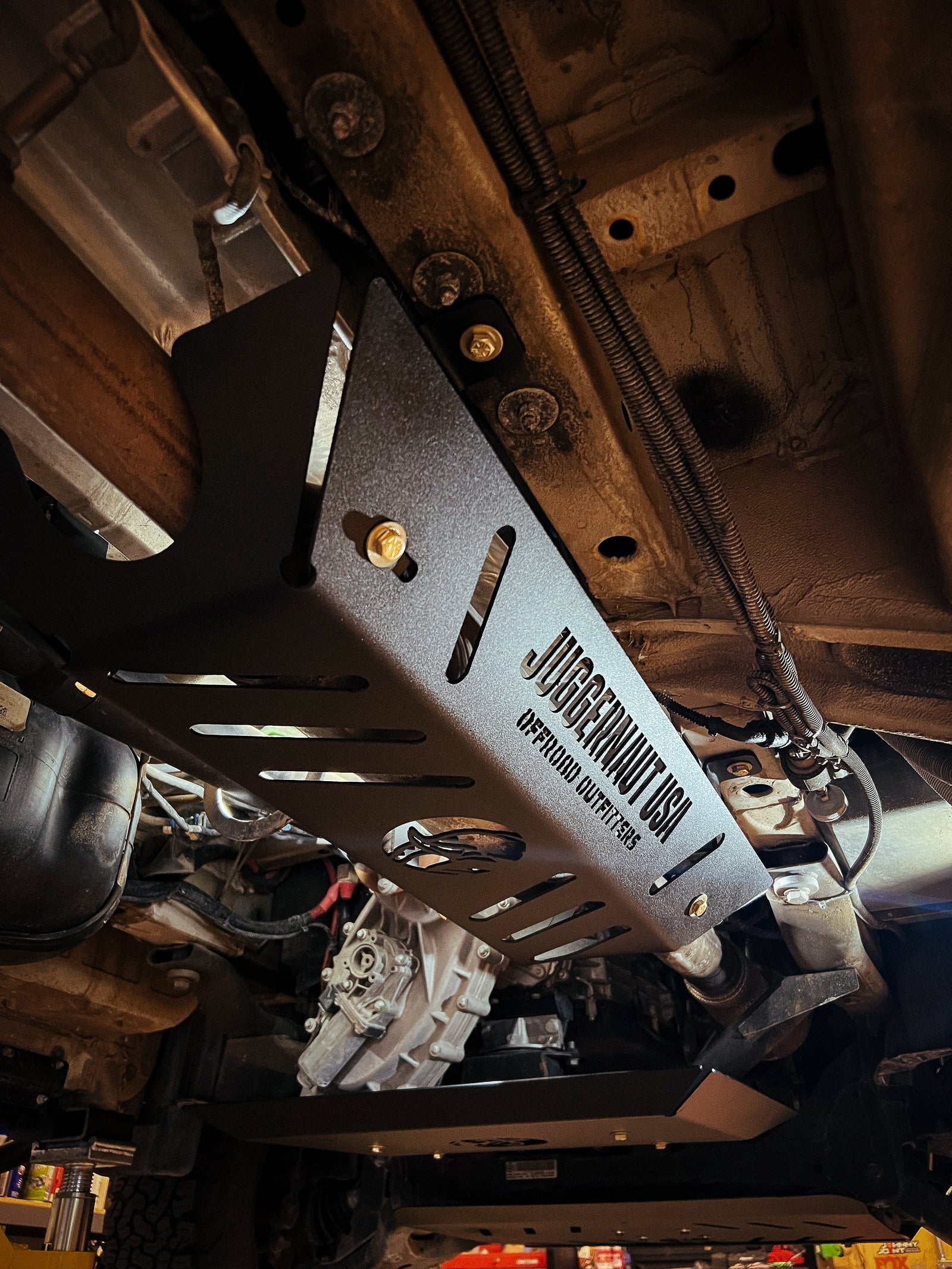 Aluminum catalytic converter guard bolted over the converter on a Mercedes Sprinter