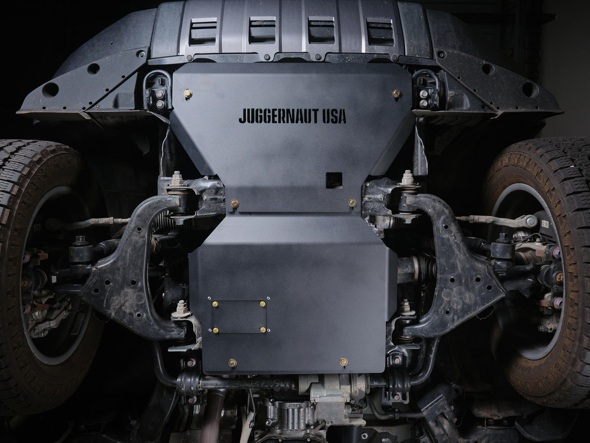 Juggernaut USA engine skid plate installed under a Toyota Land Cruiser, front view